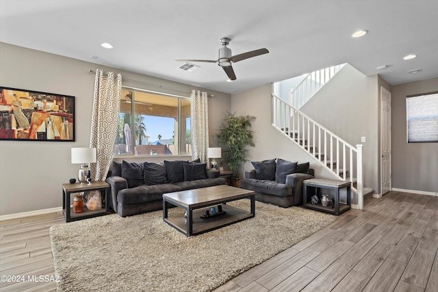 living room featuring ceiling fan and light hardwood / wood-style flooring