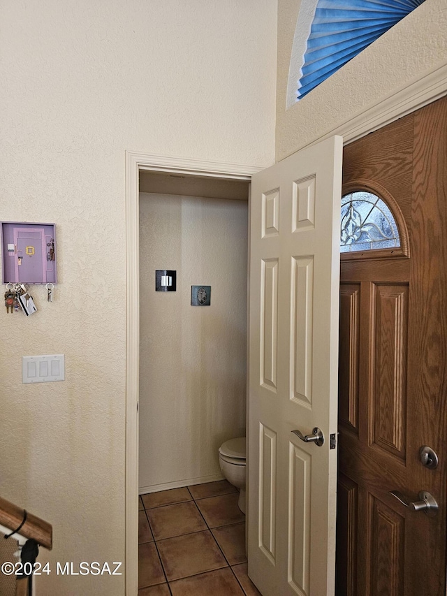 bathroom with toilet and tile patterned floors