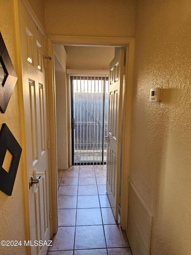 hall with light tile patterned floors