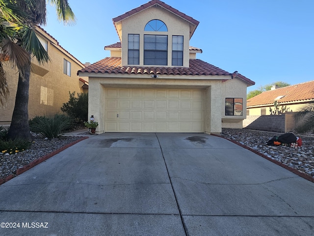 mediterranean / spanish-style house with a garage