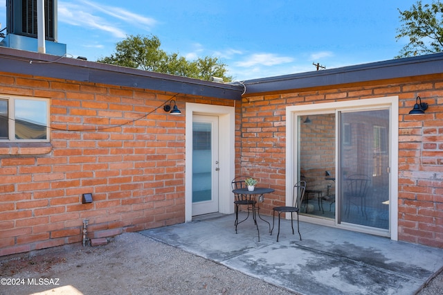 property entrance featuring a patio