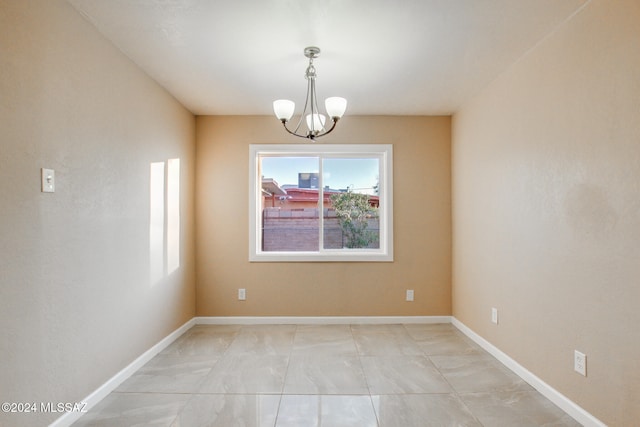 empty room with an inviting chandelier