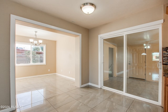 empty room featuring a notable chandelier