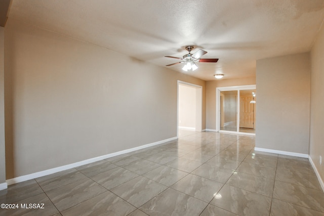 spare room with ceiling fan and a textured ceiling