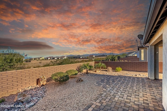 patio terrace at dusk featuring a mountain view