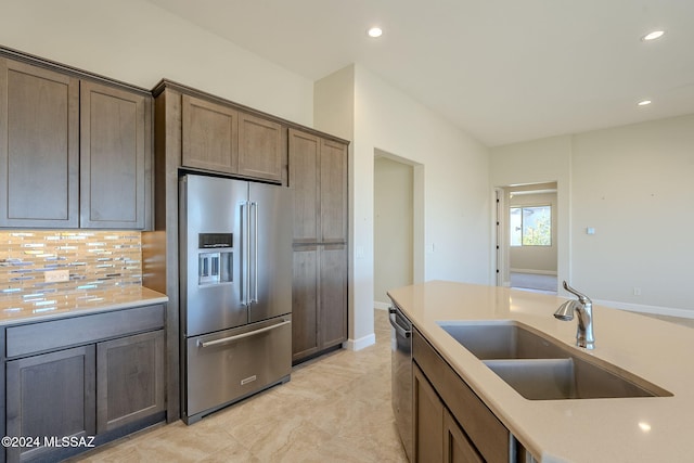 kitchen with backsplash, sink, and appliances with stainless steel finishes