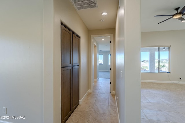 hallway featuring light tile patterned flooring