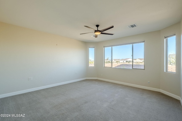 spare room featuring carpet and ceiling fan