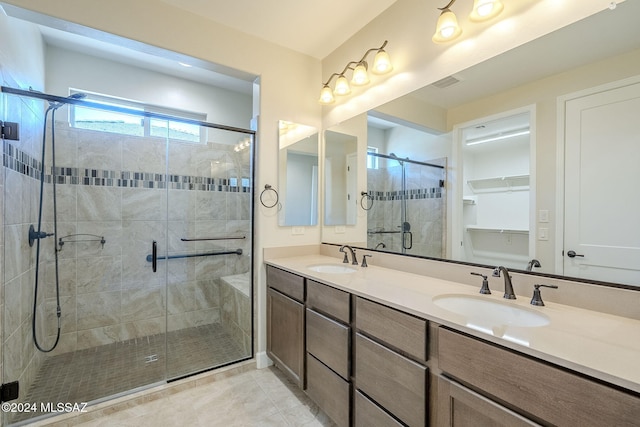 bathroom with tile patterned flooring, vanity, and an enclosed shower