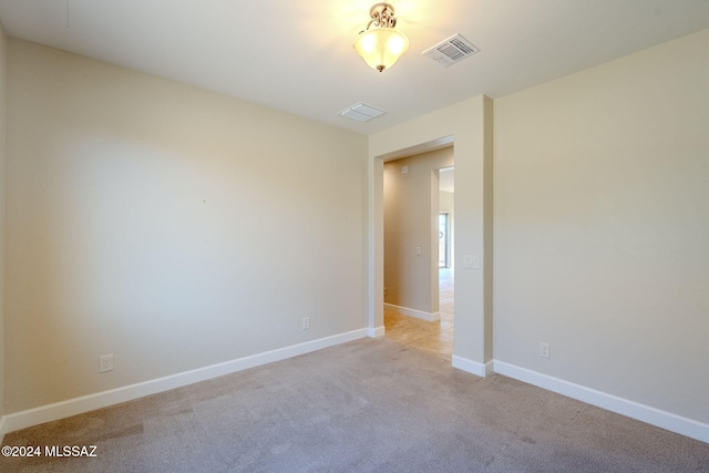 spare room with light carpet