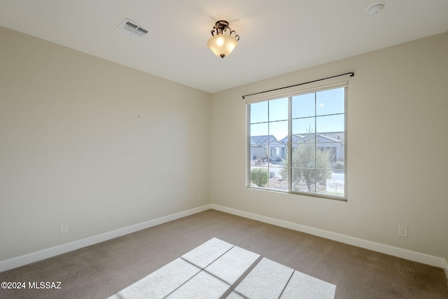 spare room featuring light colored carpet