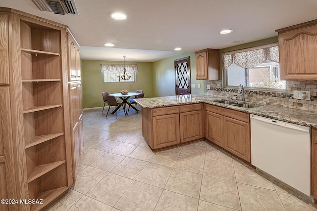 kitchen featuring pendant lighting, sink, dishwasher, a wealth of natural light, and a chandelier