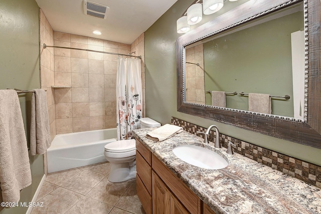 full bathroom with vanity, shower / tub combo with curtain, tile patterned floors, and toilet