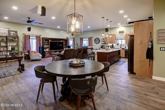 dining area with ceiling fan with notable chandelier