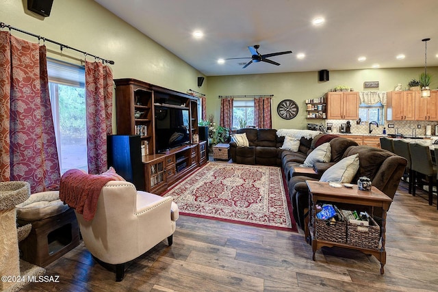 living room featuring dark wood-type flooring, ceiling fan, plenty of natural light, and sink