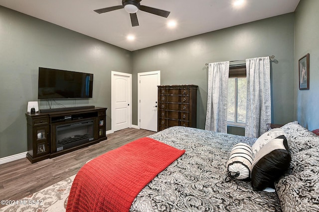 bedroom with hardwood / wood-style floors and ceiling fan