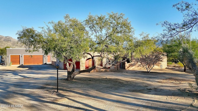 view of front facade featuring a garage and a mountain view