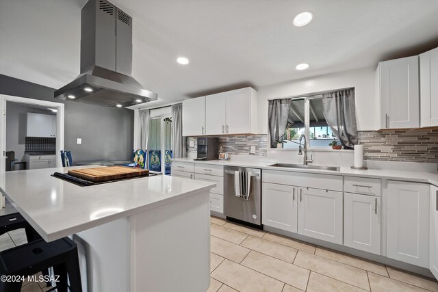 kitchen with white cabinetry, island exhaust hood, stainless steel fridge, a breakfast bar, and light tile patterned flooring