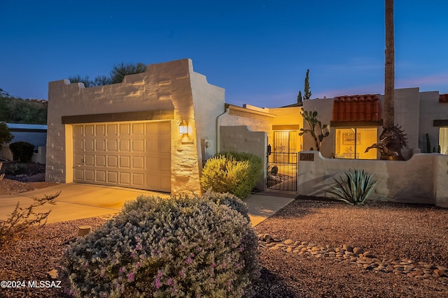 pueblo-style house with a garage