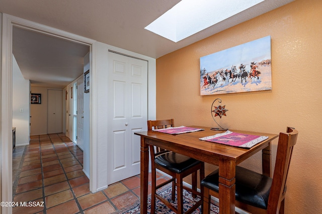 dining room with a skylight