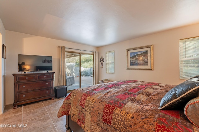 tiled bedroom featuring access to outside