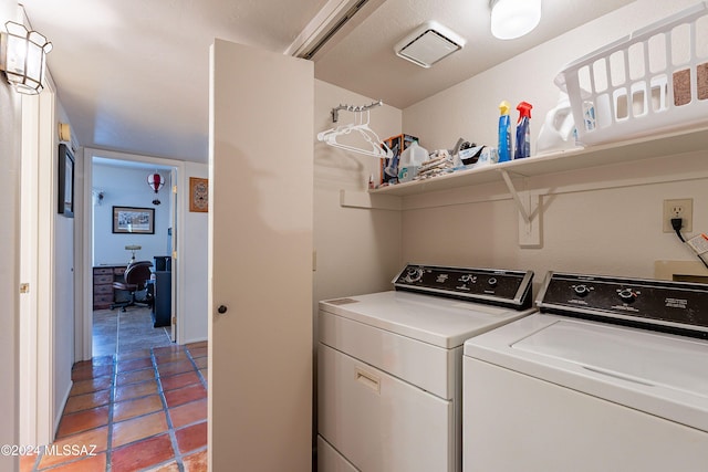 clothes washing area with washer and dryer and light tile patterned floors