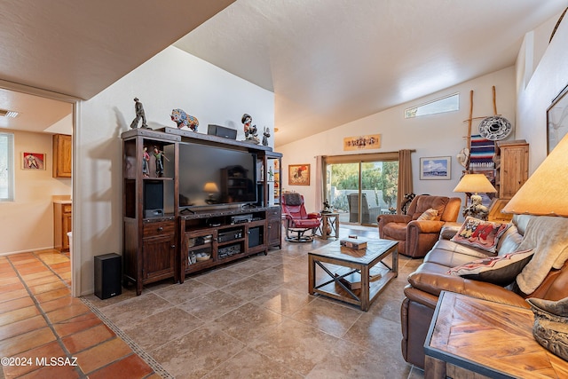 living room with lofted ceiling and tile patterned floors