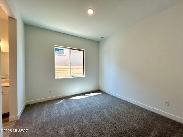 empty room with carpet flooring and baseboards