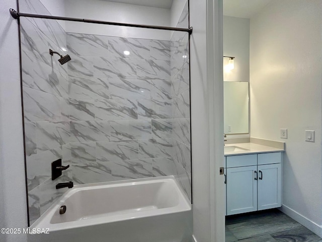 full bathroom featuring vanity, bathtub / shower combination, and baseboards