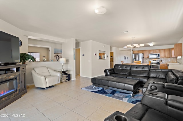 living room with light tile patterned floors and an inviting chandelier