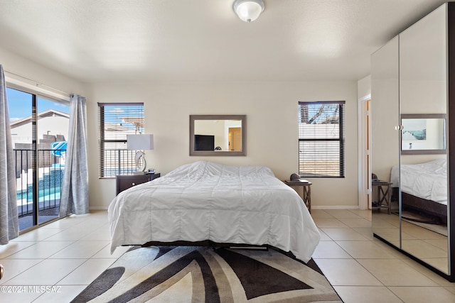 bedroom featuring light tile patterned floors and access to outside