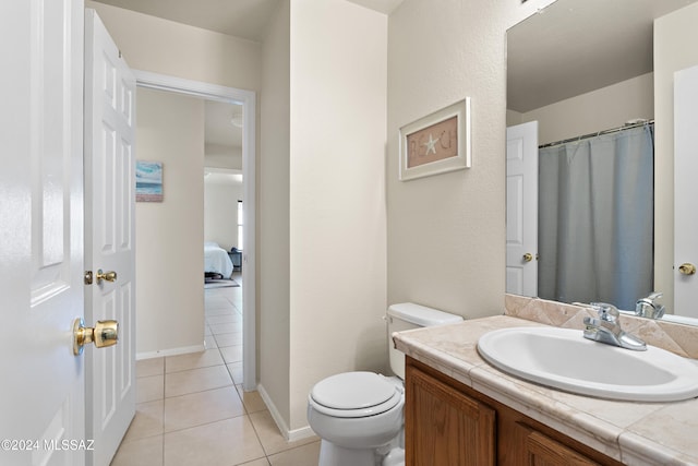 bathroom featuring tile patterned flooring, vanity, and toilet