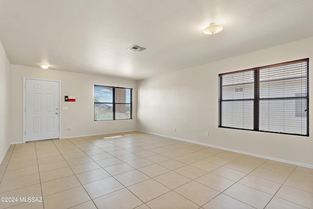 unfurnished room featuring light tile patterned flooring