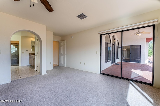 unfurnished room featuring light colored carpet and ceiling fan