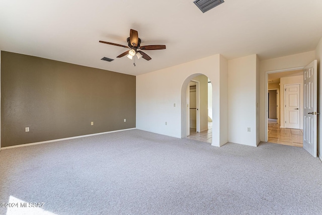 carpeted spare room with ceiling fan