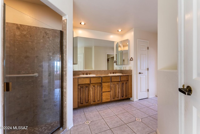 bathroom with tile patterned floors, vanity, and an enclosed shower