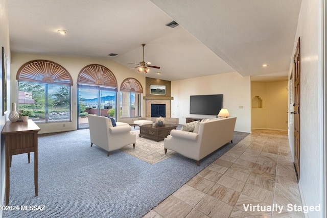 living room featuring vaulted ceiling and ceiling fan