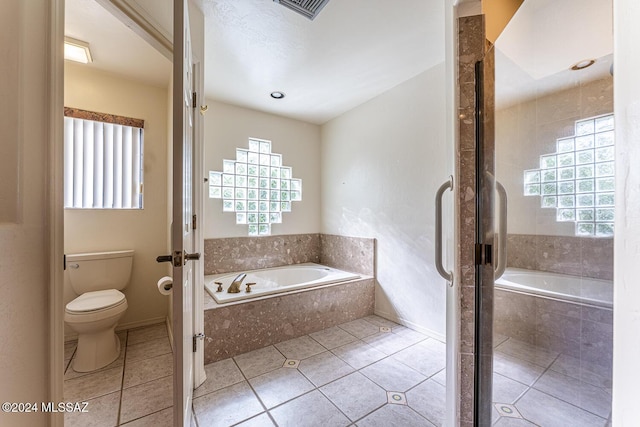 bathroom with tile patterned flooring, toilet, and independent shower and bath