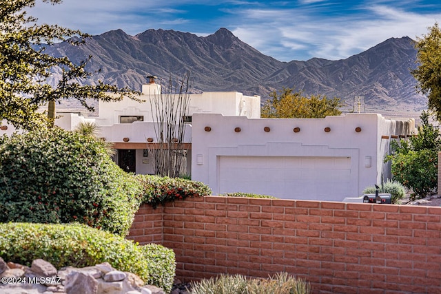 view of front facade featuring a mountain view and a garage