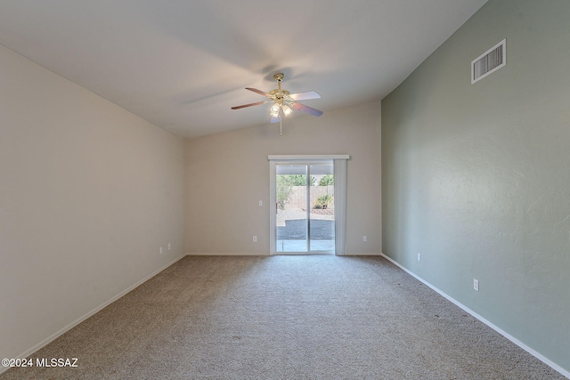 carpeted spare room featuring ceiling fan and lofted ceiling