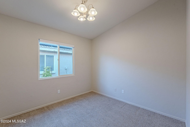 unfurnished room with carpet, vaulted ceiling, and an inviting chandelier