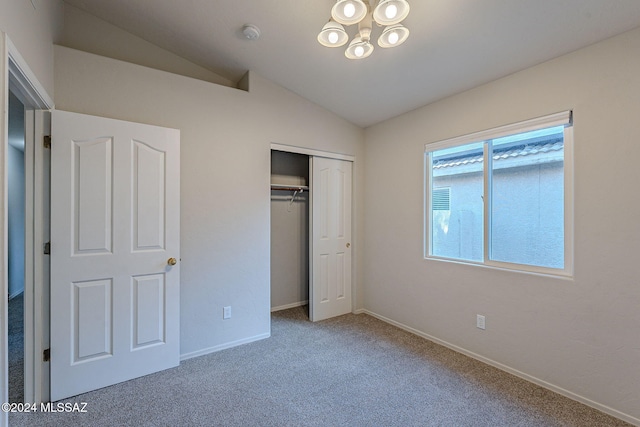 unfurnished bedroom featuring carpet floors, a closet, and lofted ceiling