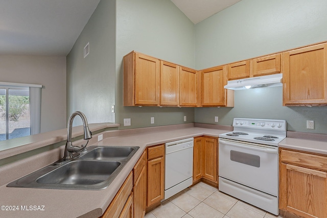 kitchen featuring sink, kitchen peninsula, vaulted ceiling, white appliances, and light tile patterned floors