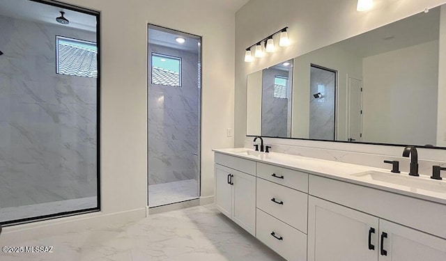full bath with double vanity, a sink, marble finish floor, and a marble finish shower