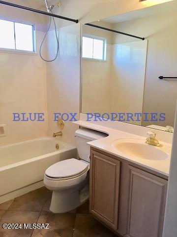 full bathroom featuring tile patterned flooring, vanity, shower / bathtub combination, and a wealth of natural light