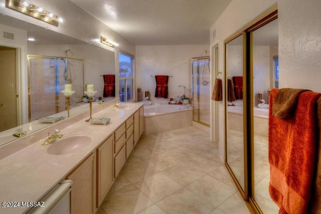 bathroom featuring tile patterned flooring, vanity, and plus walk in shower