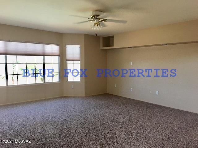 unfurnished room featuring carpet flooring and ceiling fan