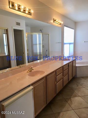 bathroom with tile patterned floors, vanity, and independent shower and bath