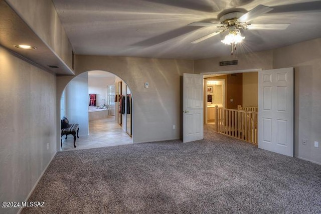 carpeted empty room with ceiling fan