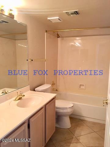 full bathroom featuring toilet, vanity, tile patterned floors, and shower / washtub combination